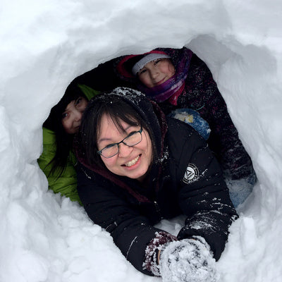 Children playing in a snow fort.